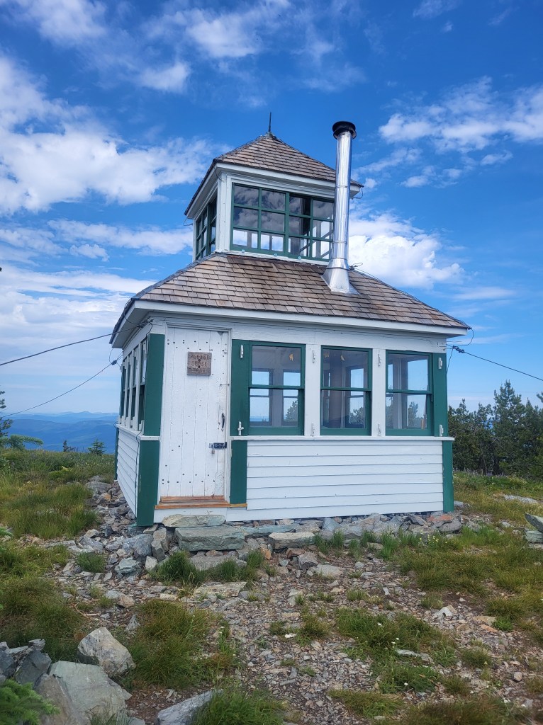 A cupola lookout with fresh paint and clouds in the background.