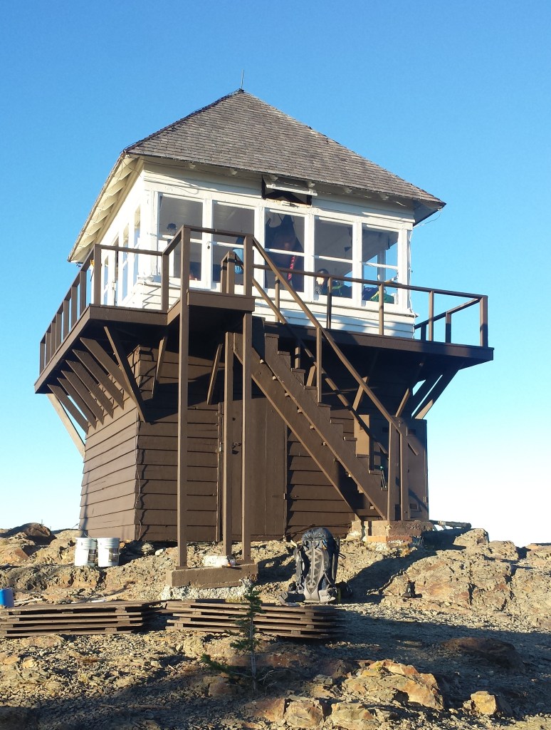 A lookout with stairs on top of a mountain